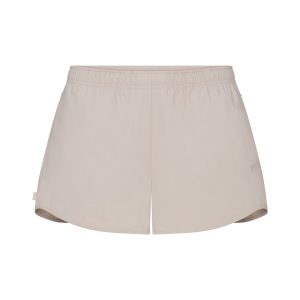 NikeSKIMS WOVEN NYLON 2.5 RUNNER SHORT | STONE